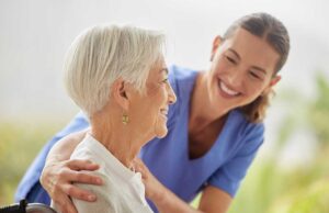 Older resident reviews care documents with a family member at a table in an assisted living apartment.